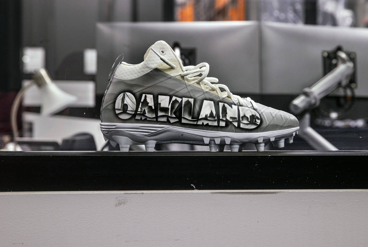 A decorative Oakland cleat sits on a desk in the equipment room within the Las Vegas Raiders he ...