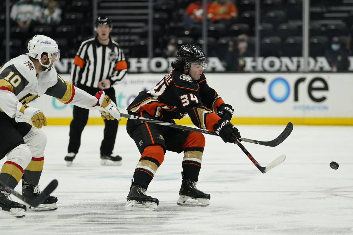 Vegas Golden Knights center Nicolas Roy (10) and Anaheim Ducks defenseman Jamie Drysdale (34) r ...