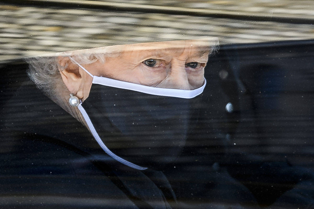 Britain's Queen Elizabeth II follows the coffin in a car as it makes it's way past the Round To ...