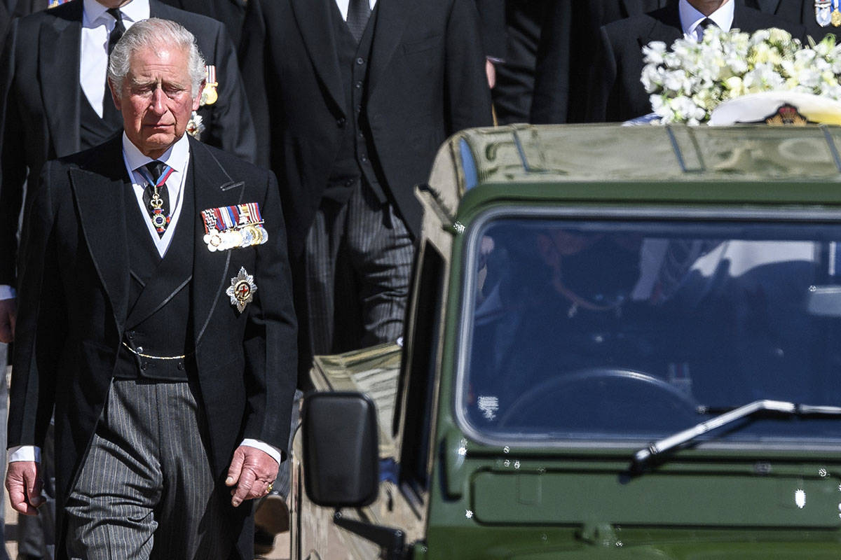 Britain's Prince Charles follows the coffin as it makes it's way past the Round Tower during th ...
