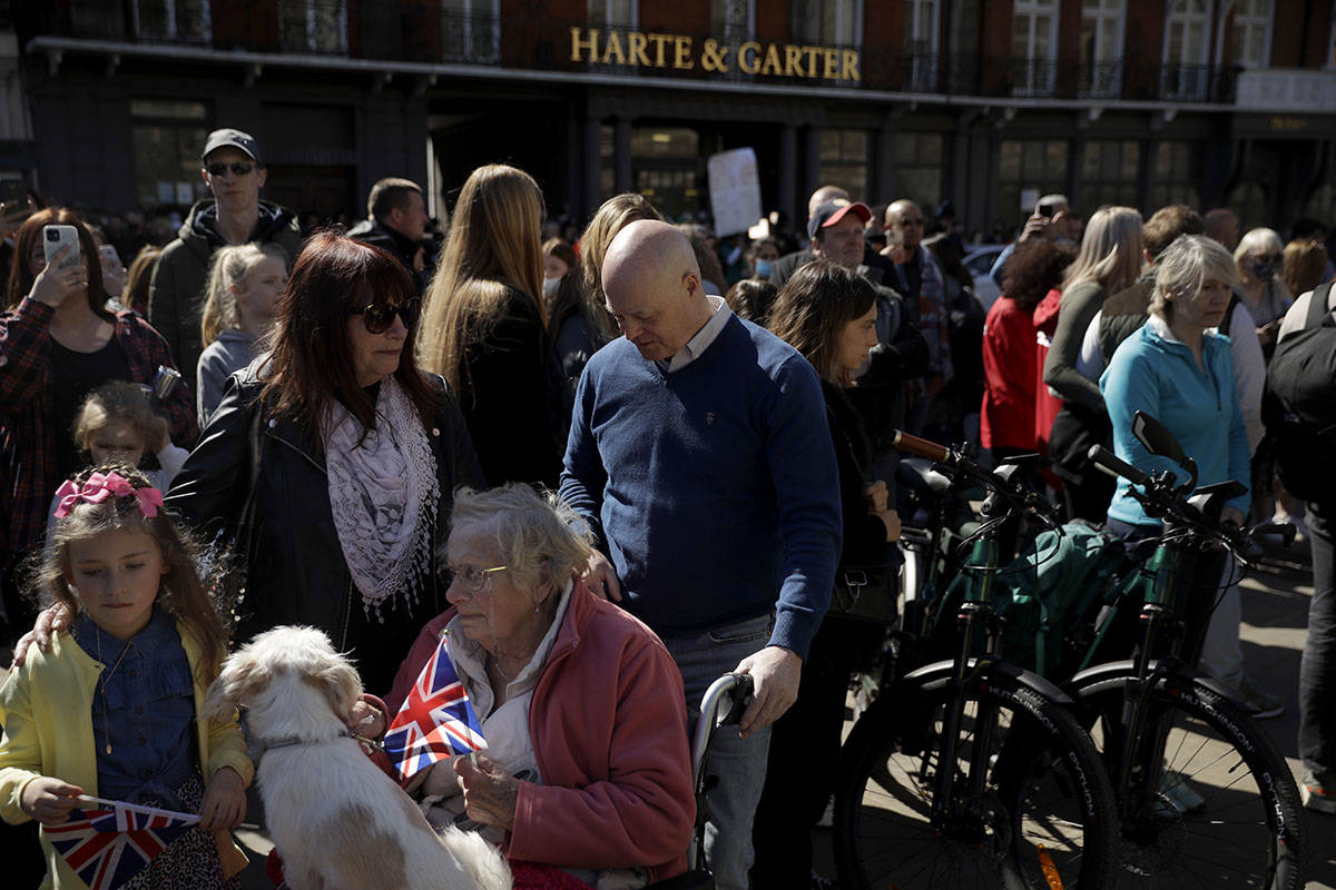People observe a minute's silence outside Windsor Castle during the funeral of Britain's Prince ...