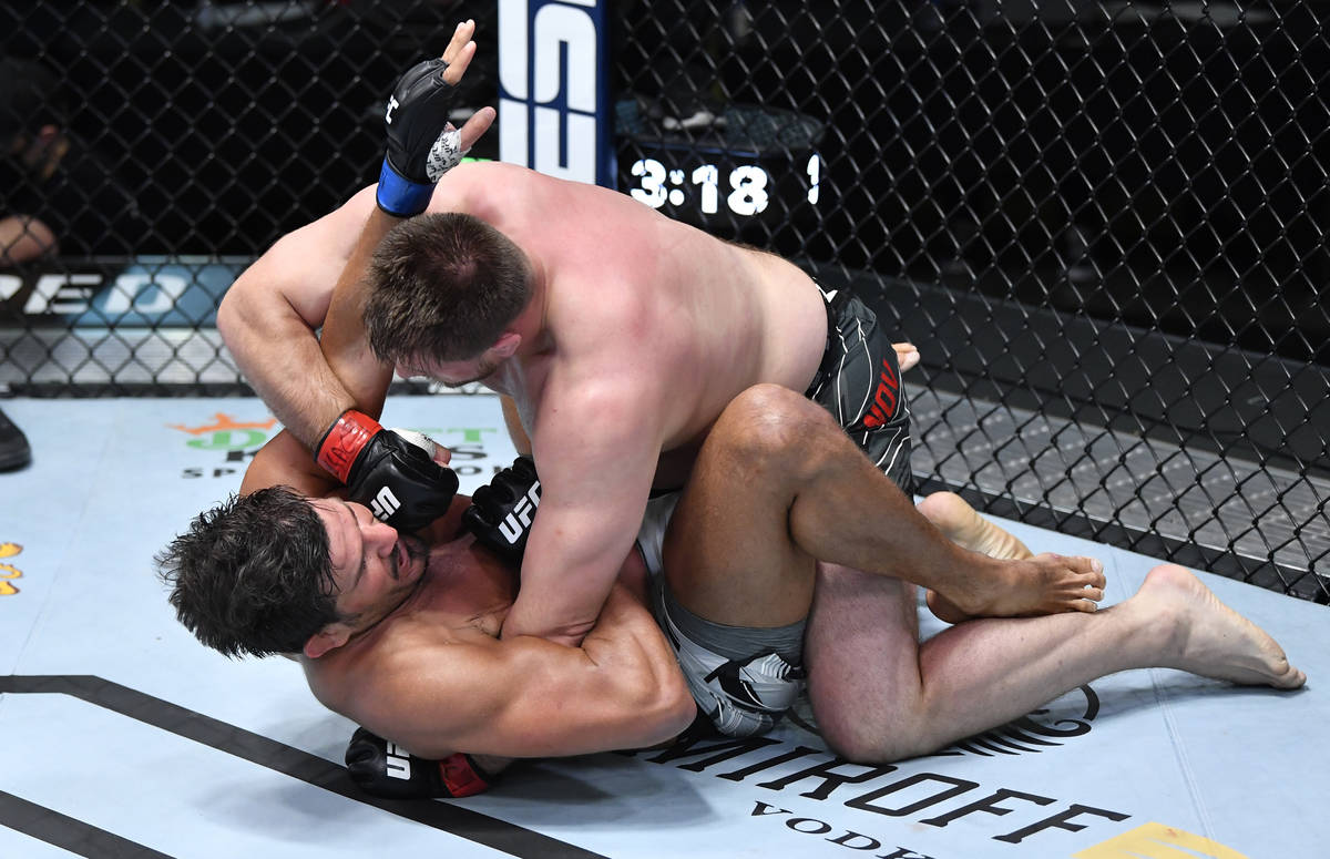 Alexandr Romanov of Moldova punches Juan Espino of Spain in a heavyweight fight during the UFC ...