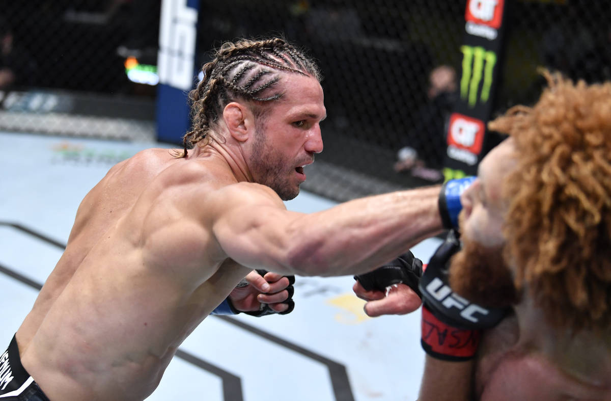 Alexander Munoz punches Luis Pena in a lightweight fight during the UFC Fight Night event at UF ...