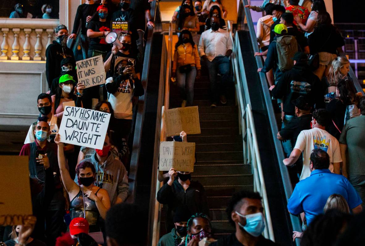 People participate in a demonstration in solidarity with the families of Daunte Wright and Adam ...