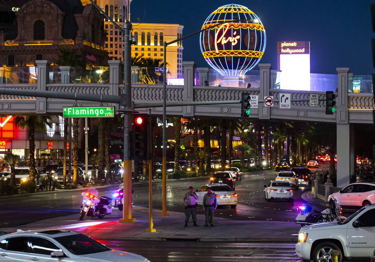 Las Vegas police watch from a distance as people participate in a demonstration in solidarity w ...