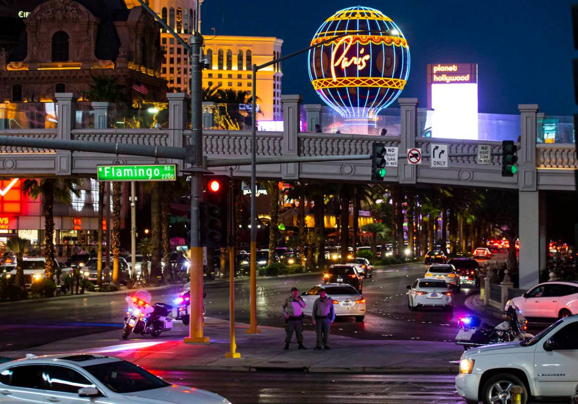 Las Vegas police watch from a distance as people participate in a demonstration in solidarity w ...