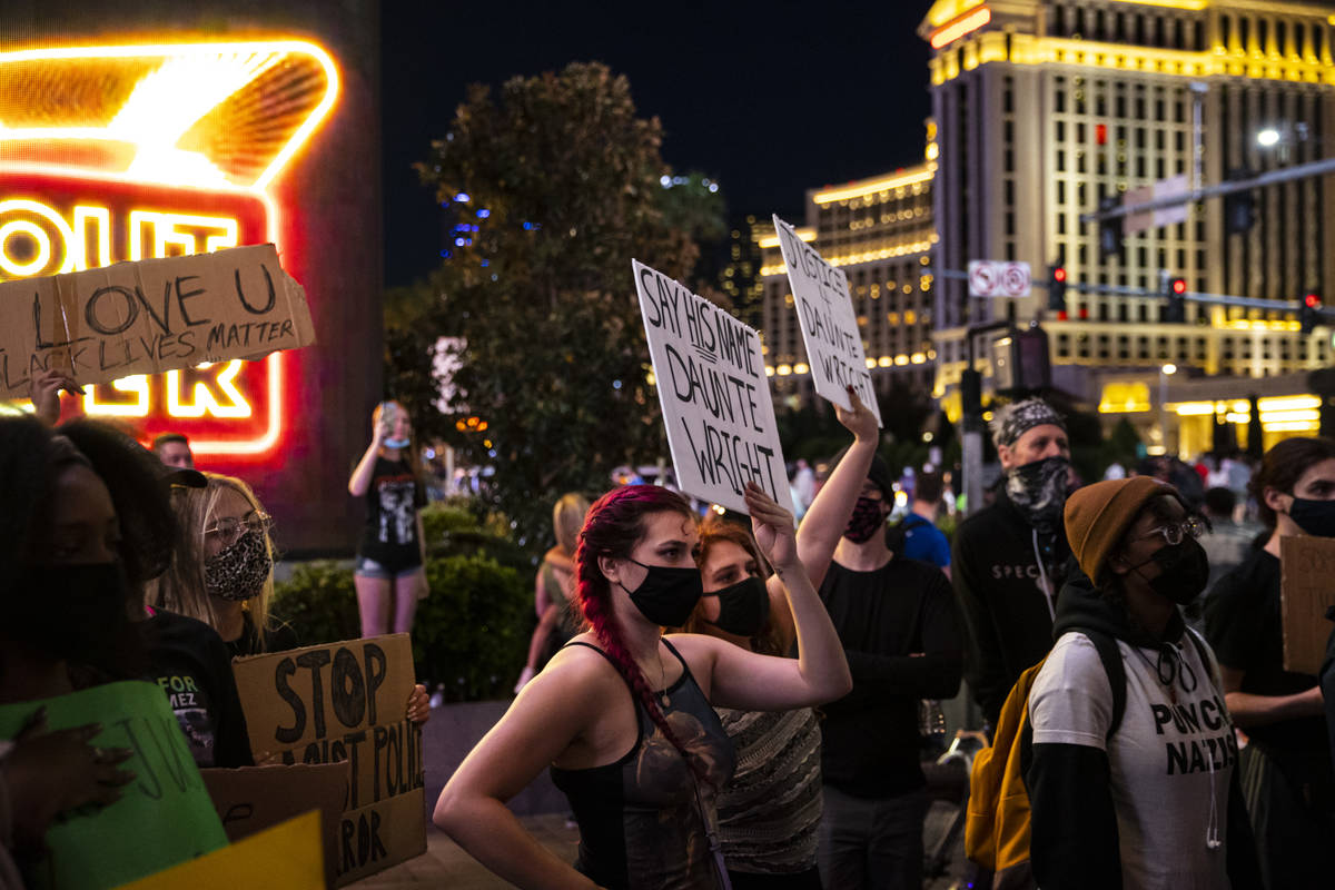 People participate in a demonstration in solidarity with the families of Daunte Wright and Adam ...