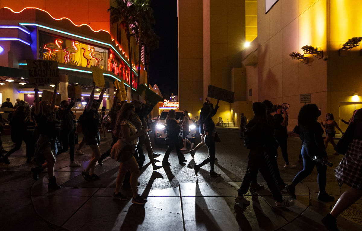 People participate in a demonstration in solidarity with the families of Daunte Wright and Adam ...