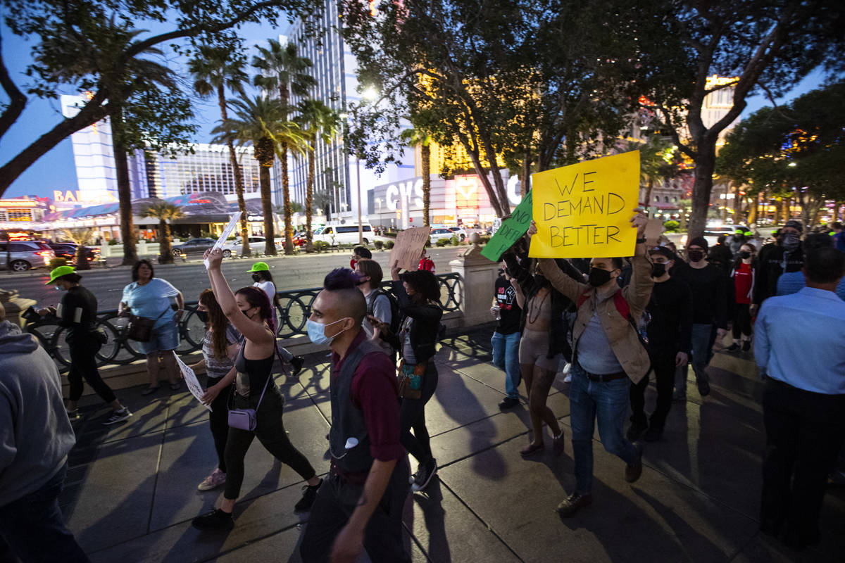 People participate in a demonstration in solidarity with the families of Daunte Wright and Adam ...