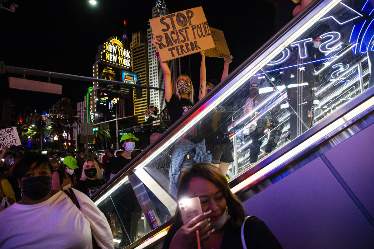 People participate in a demonstration in solidarity with the families of Daunte Wright and Adam ...