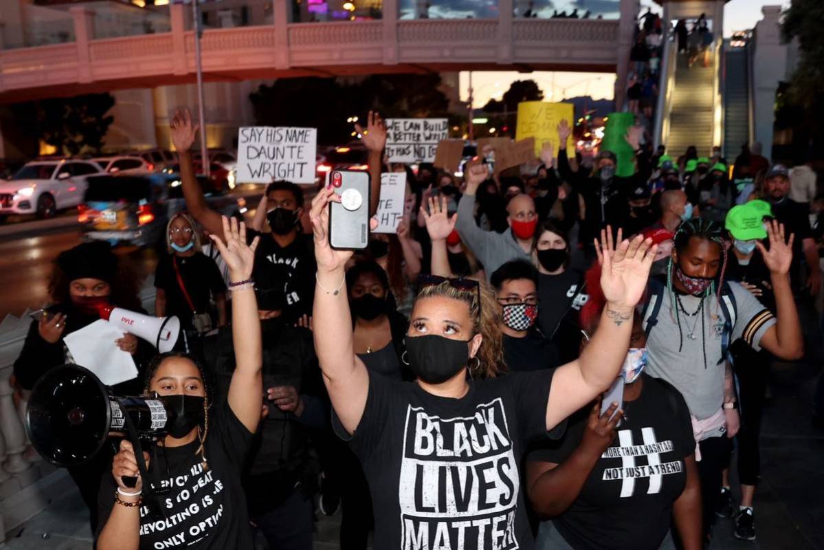 Protesters, including Desiree Smith, left, and Leinati Hackley, of More Than A Hashtag, march a ...