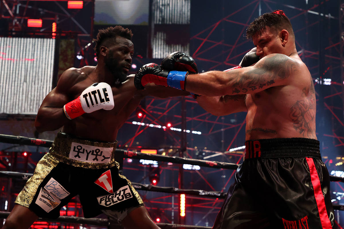 ATLANTA, GEORGIA - APRIL 17: Steve Cunningham punches Frank Mir in their heavyweight bout durin ...