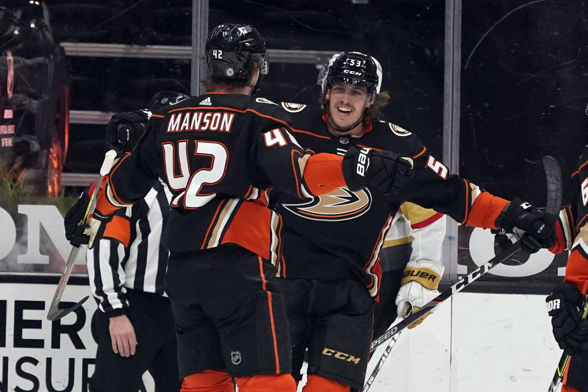 Anaheim Ducks left wing Max Comtois, right, celebrates with Josh Manson (42) after scoring duri ...