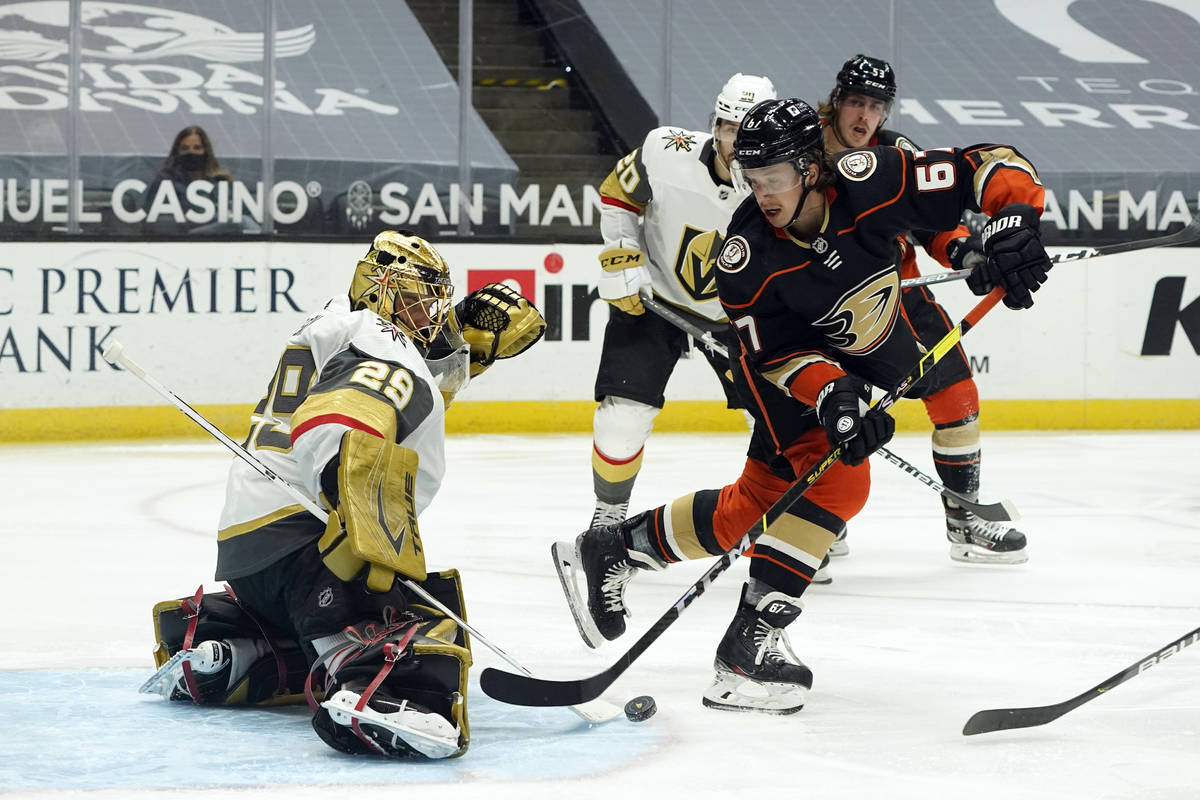 Vegas Golden Knights goaltender Marc-Andre Fleury, left, stops a shot from Anaheim Ducks left w ...