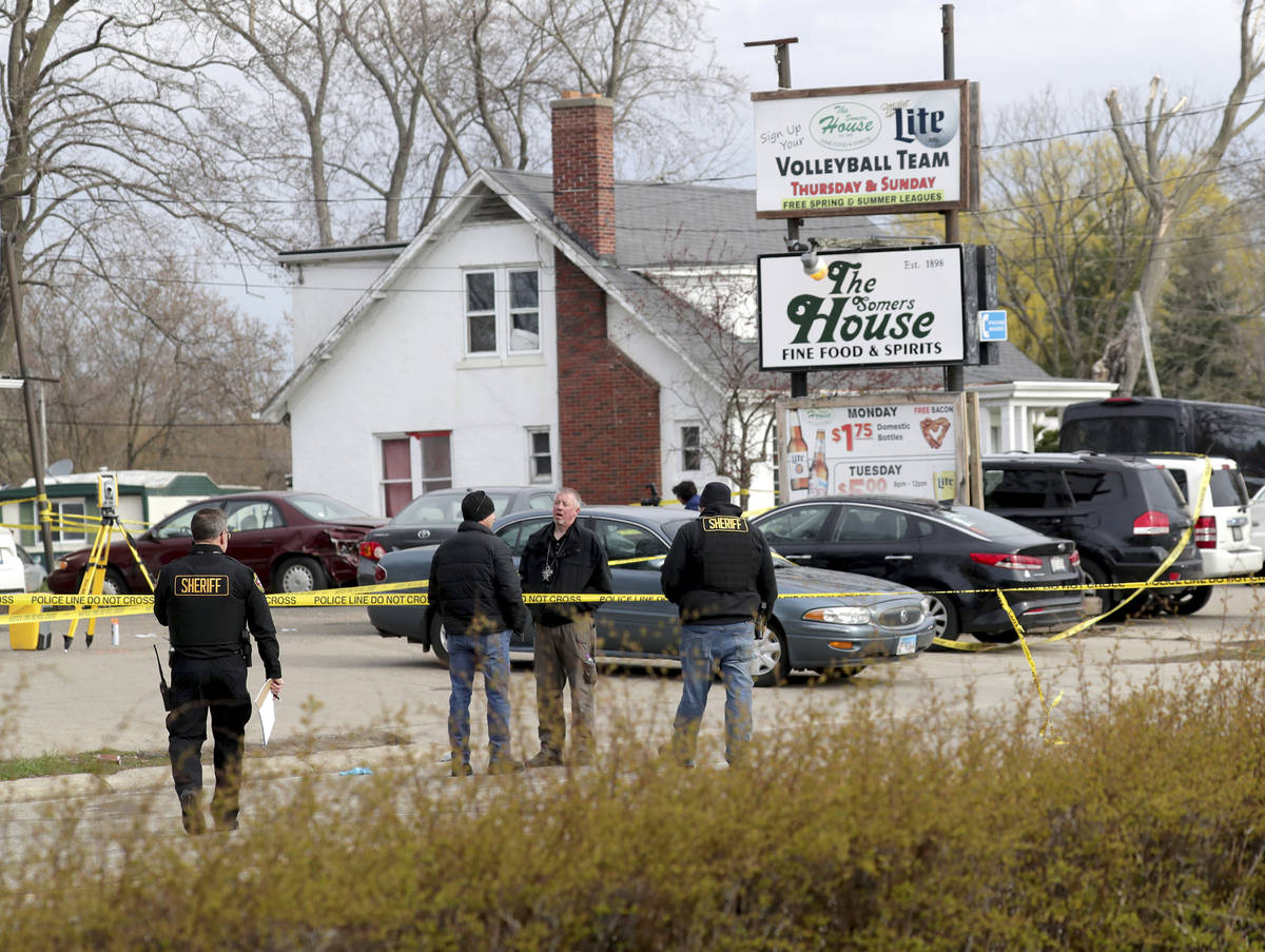 Officials investigate the scene of a deadly shooting at Somers House Tavern in Kenosha, Wis., S ...