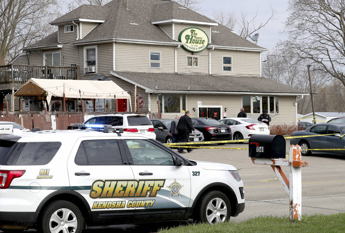 Officials investigate the scene a deadly shooting at Somers House Tavern in Kenosha, Wis., Sund ...