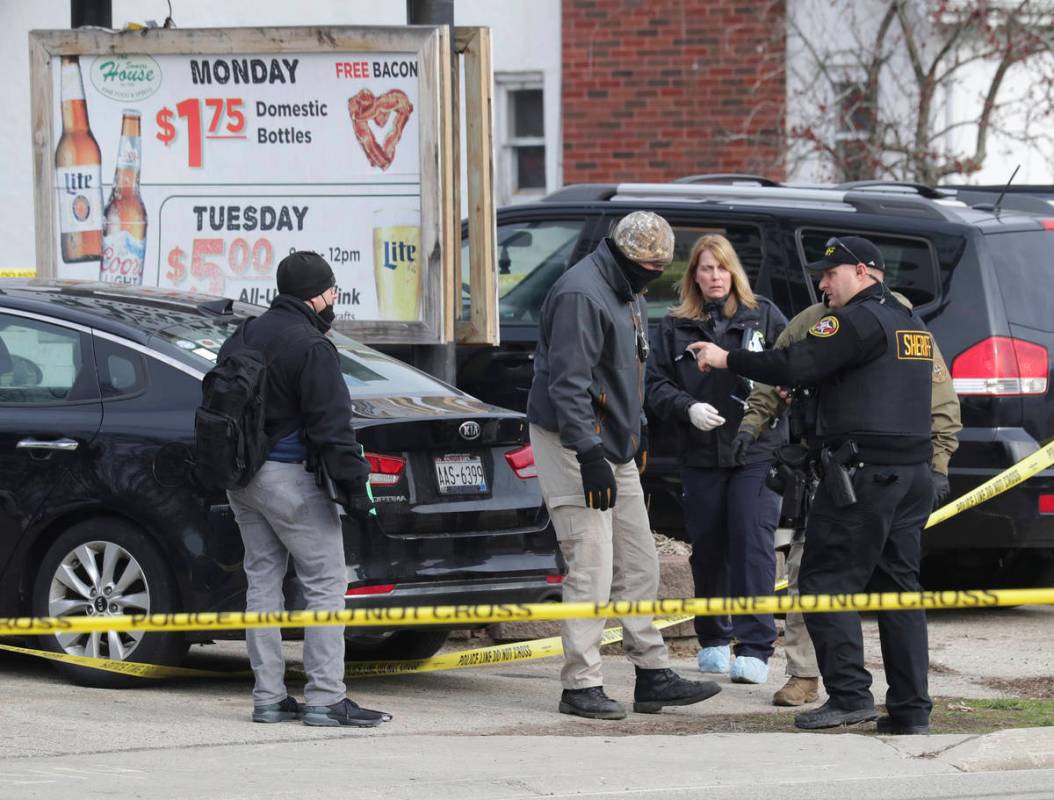 Officials investigate the scene of a deadly shooting at Somers House Tavern in Kenosha, Wis., S ...