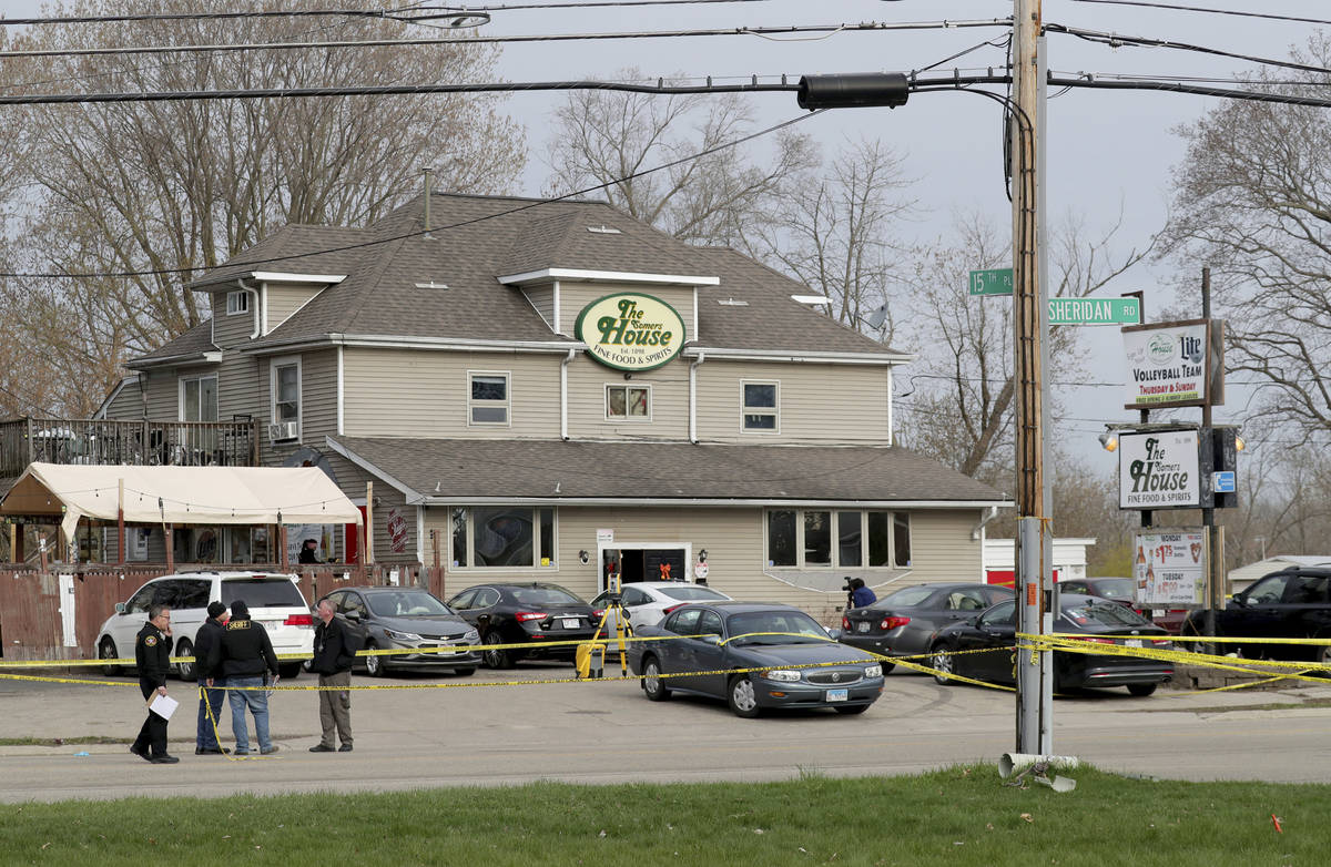 Officials investigate the scene of a deadly shooting at Somers House Tavern in Kenosha, Wis., S ...