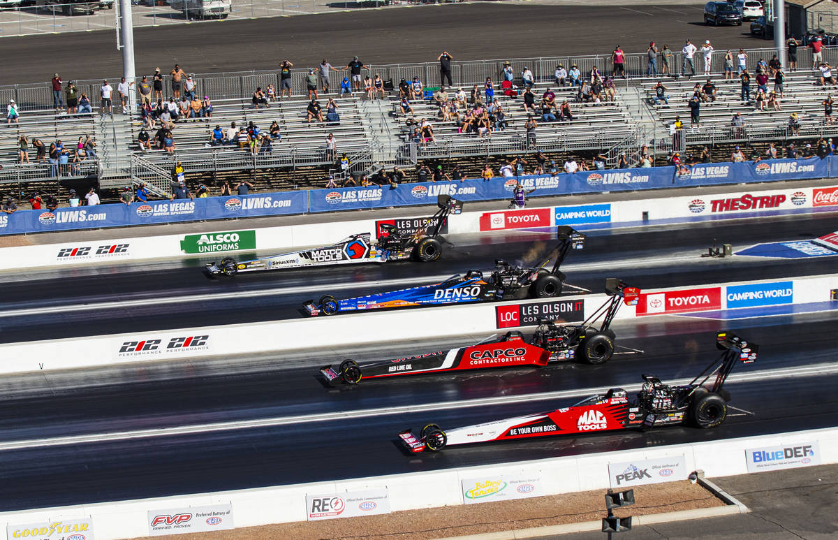 Steve Torrence, third from left, competes to win against drivers, from left, Antron Brown, Clay ...
