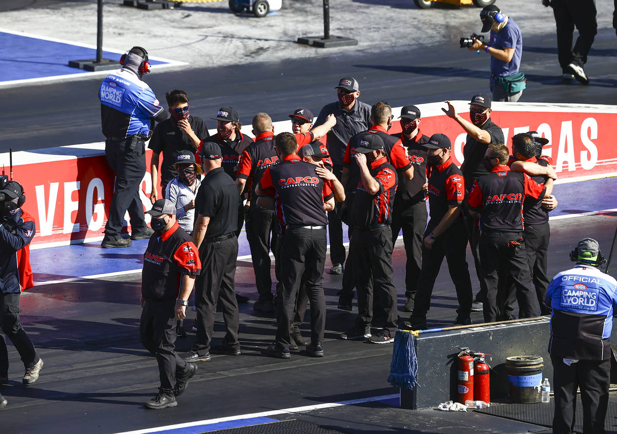 Crew members of Steve Torrence celebrate his Top Fuel win at the Denso Spark Plugs NHRA Four-Wi ...