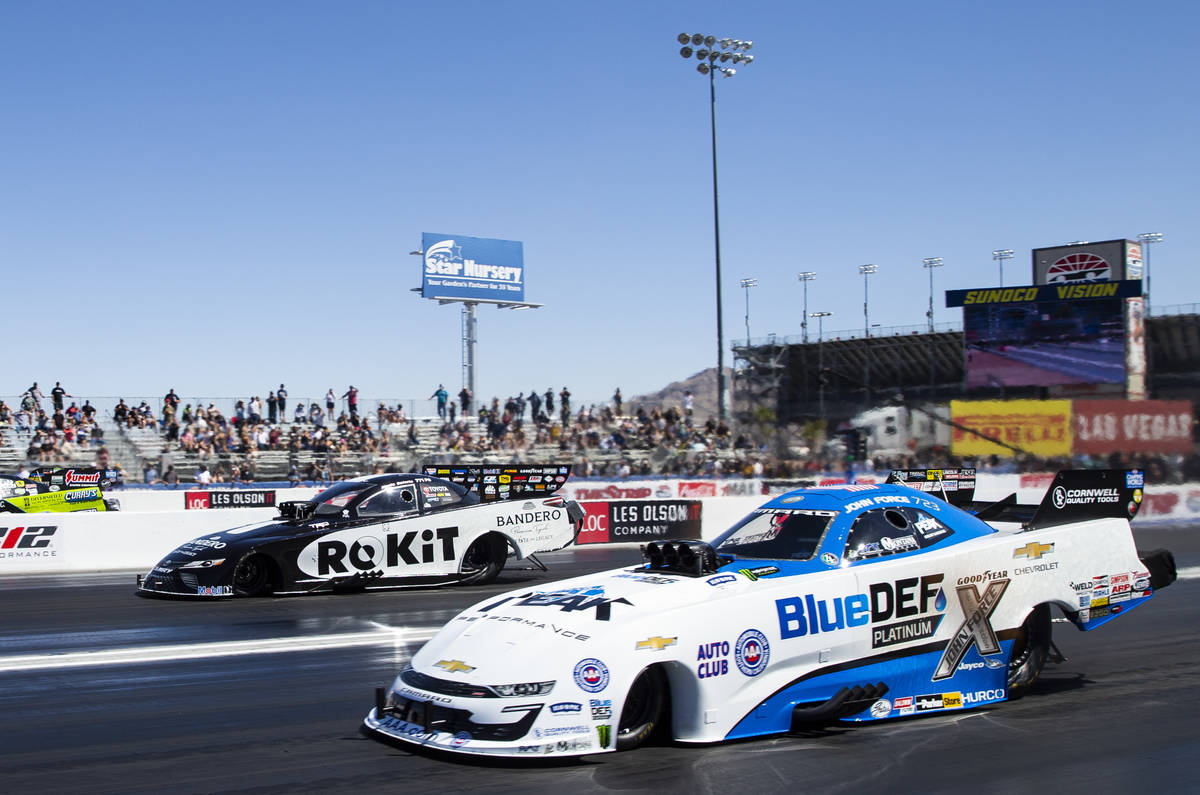 John Force, right, competes in the second elimination round of Funny Car at the Denso Spark Plu ...