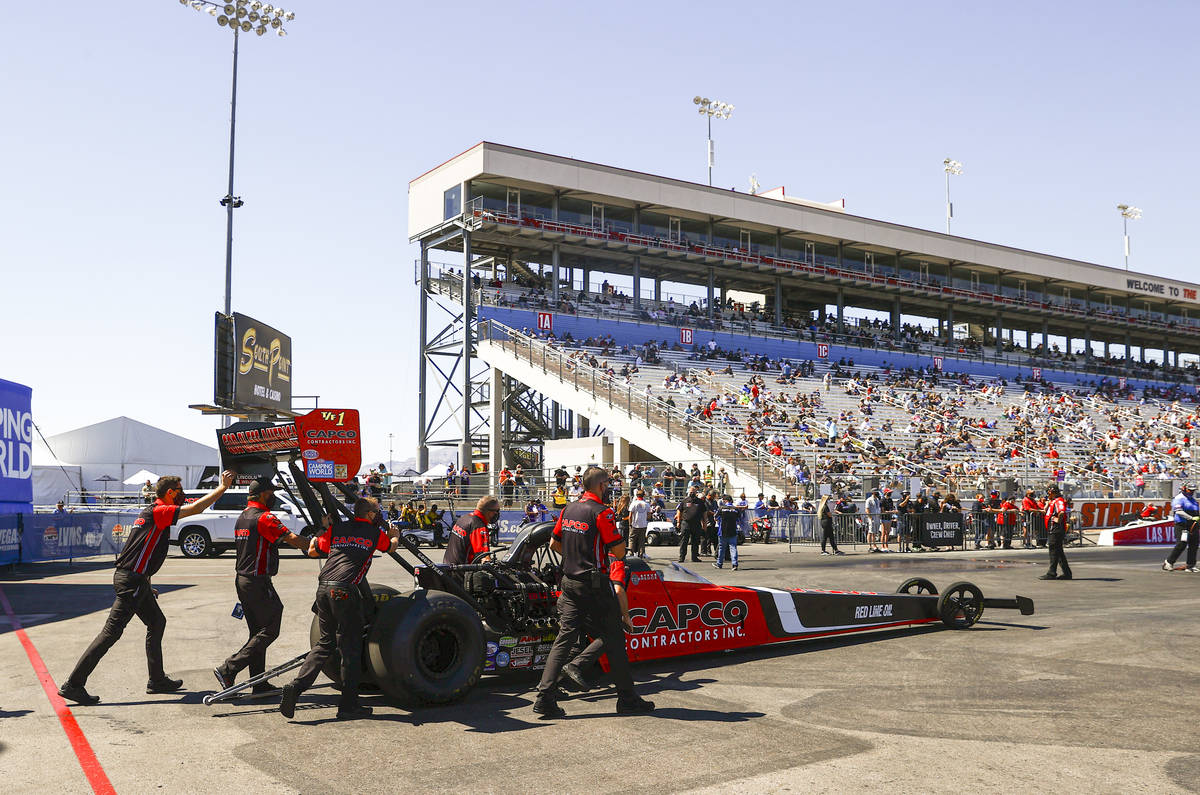 Crew members for Steve Torrence prepare for the second round of eliminations in Top Fuel at the ...