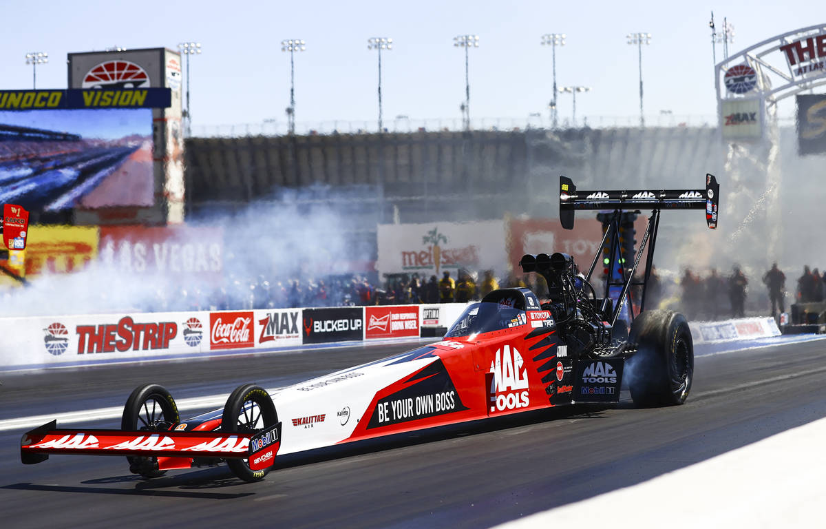 Doug Kalitta does a burnout during the final round of Top Fuel at the Denso Spark Plugs NHRA Fo ...