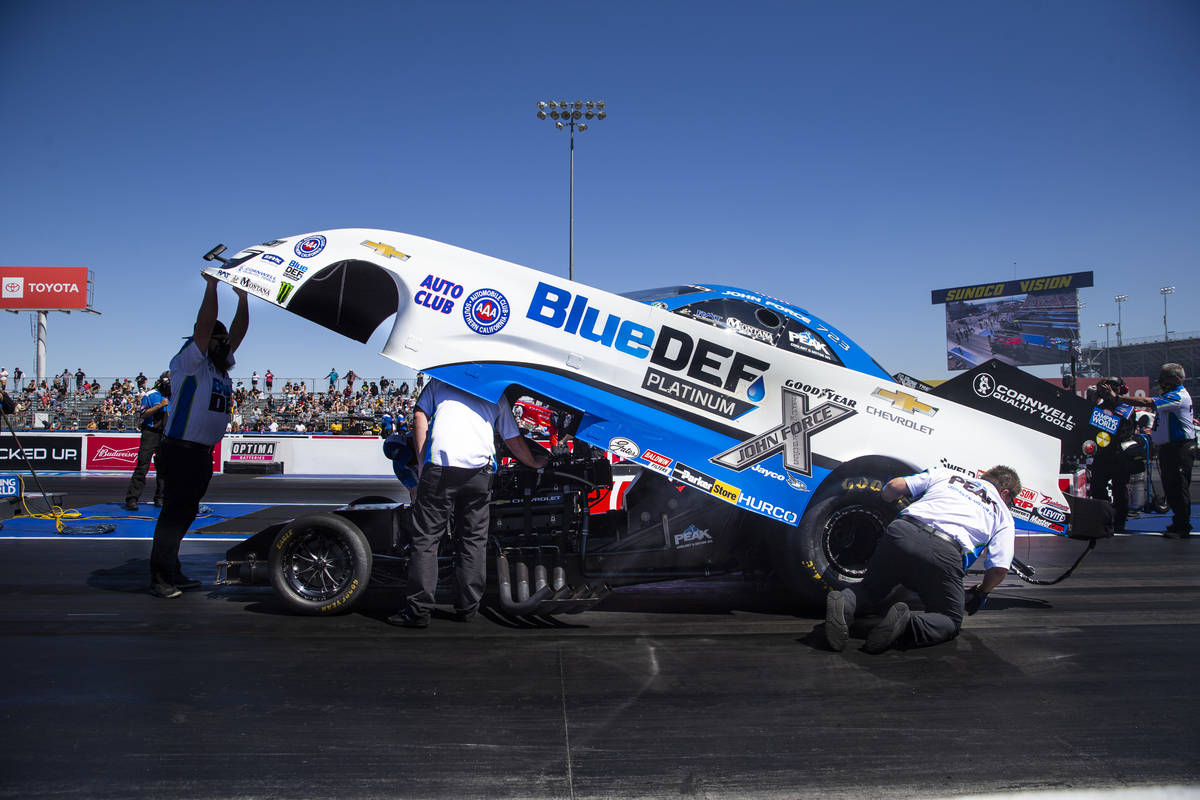 Crew members for John Force make adjustments for second elimination round of Funny Car at the D ...