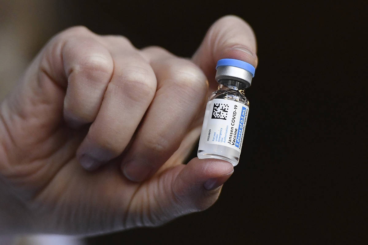 FILE - In this March 3, 2021, file photo, Johnson & Johnson COVID-19 vaccine is held by pha ...