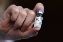 FILE - In this March 3, 2021, file photo, Johnson & Johnson COVID-19 vaccine is held by pha ...