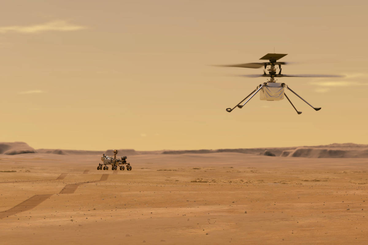 This illustration made available by NASA depicts the Ingenuity helicopter on Mars after launchi ...
