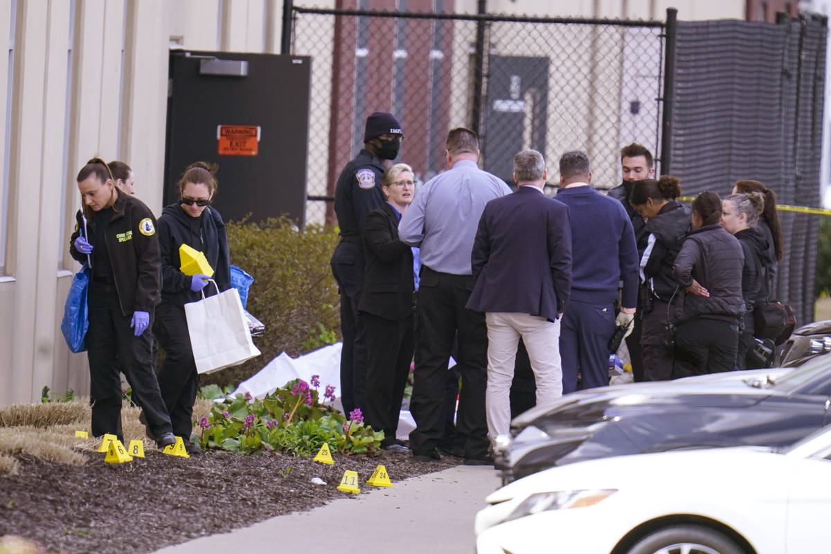 Authorities confer at the scene where multiple people were shot at the FedEx Ground facility ea ...