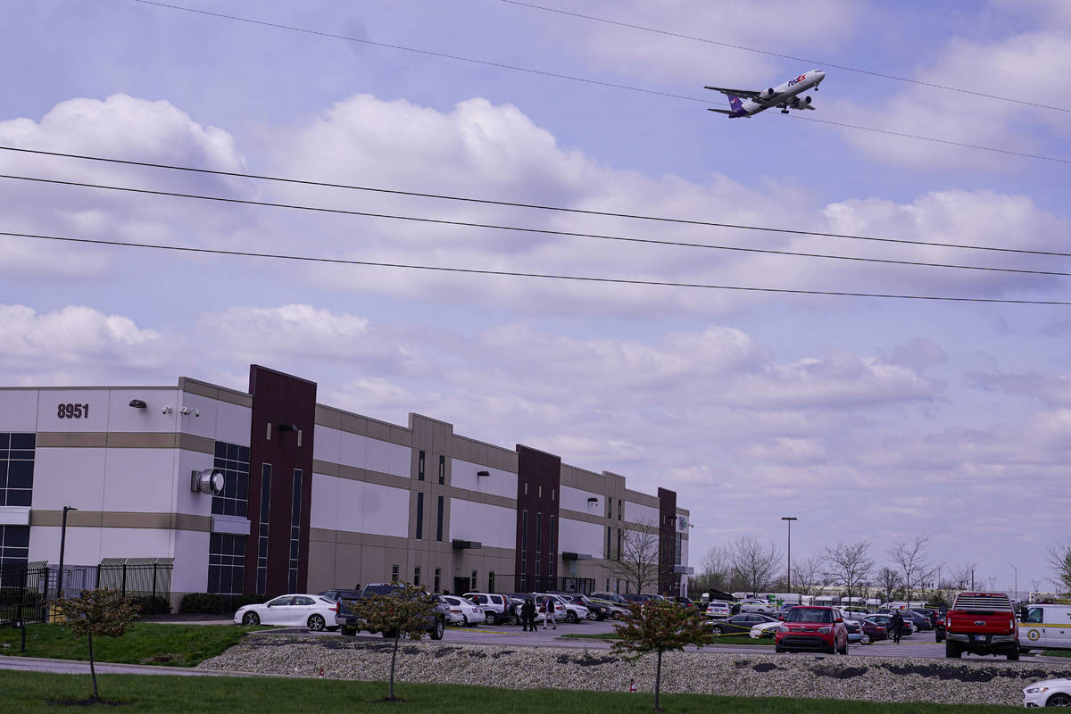 A FedEx flight on final approach flies over the FexEx Ground facility, Friday, April 16, 2021, ...