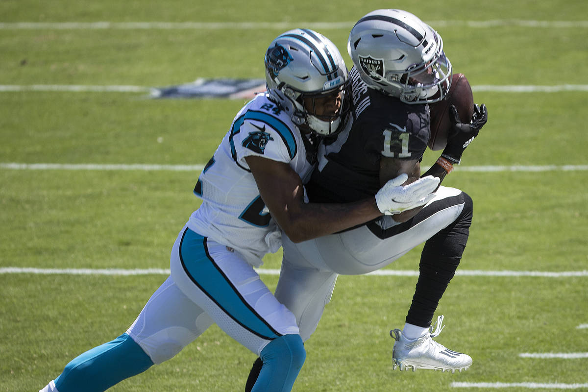 Las Vegas Raiders wide receiver Henry Ruggs III (11) fights for a reception with Carolina Panth ...