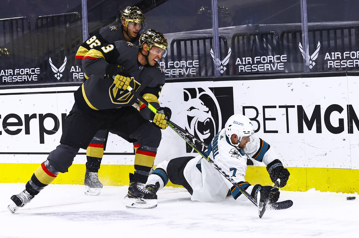 Golden Knights' Brayden McNabb (3) and San Jose Sharks' Dylan Gambrell (7) fight for the puck d ...