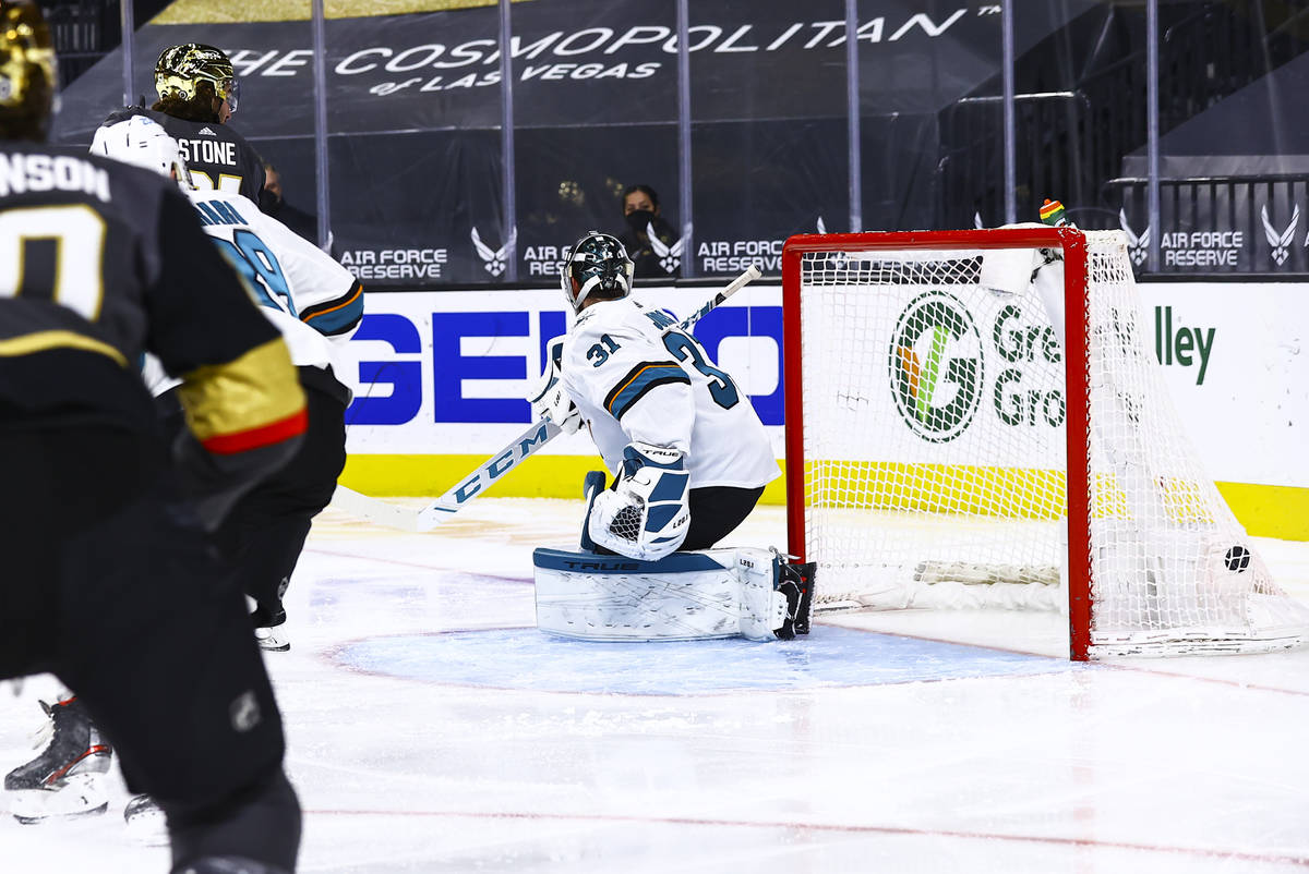 Golden Knights' Mark Stone, left, scores past San Jose Sharks goaltender Martin Jones (31) duri ...