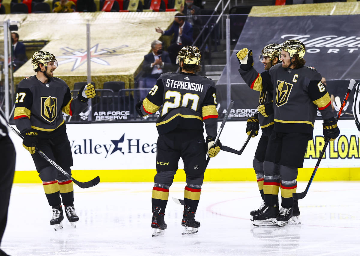 Golden Knights' Mark Stone (61) celebrates his goal with teammates during the second period of ...