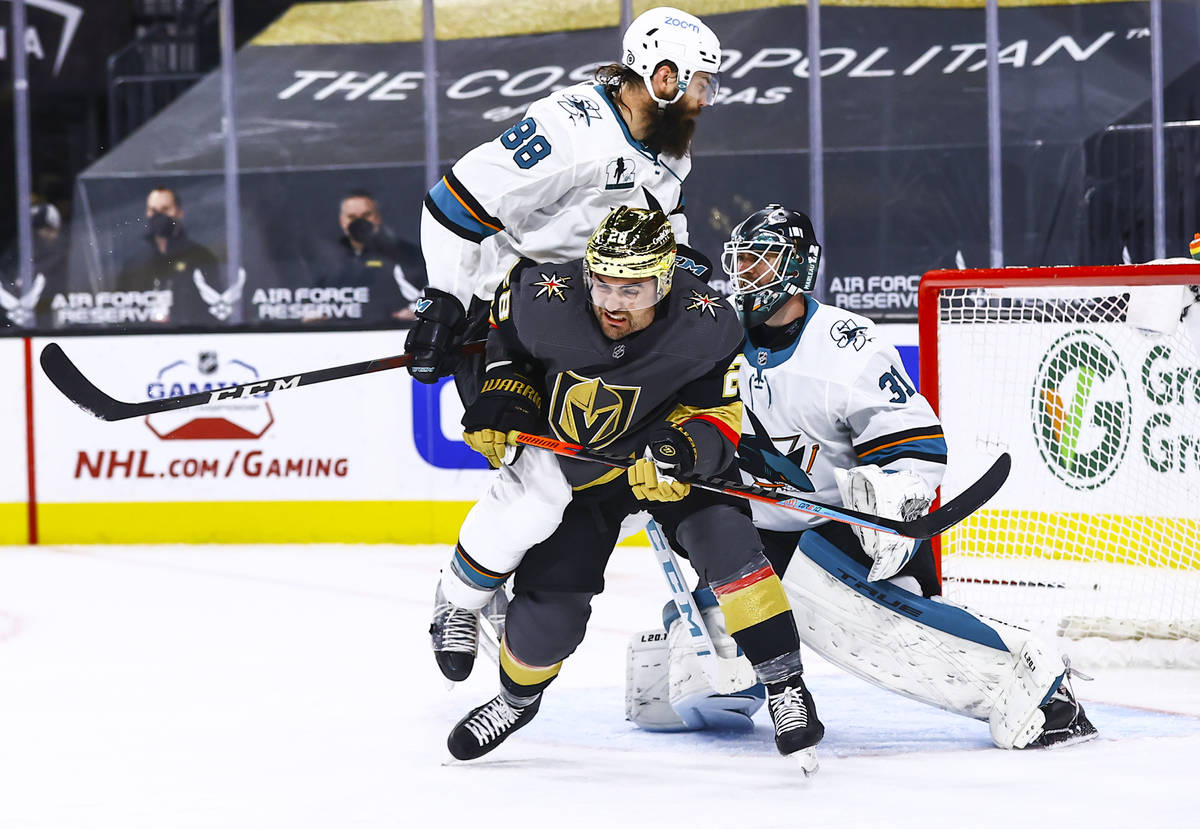 San Jose Sharks' Brent Burns (88) pushes Golden Knights' William Carrier (28) in front of San J ...