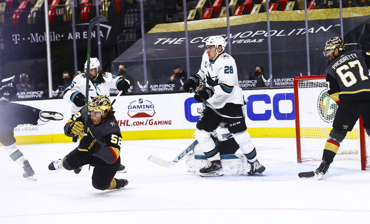 Golden Knights' Dylan Coghlan (52) gets tripped up in front of San Jose Sharks' Timo Meier (28) ...