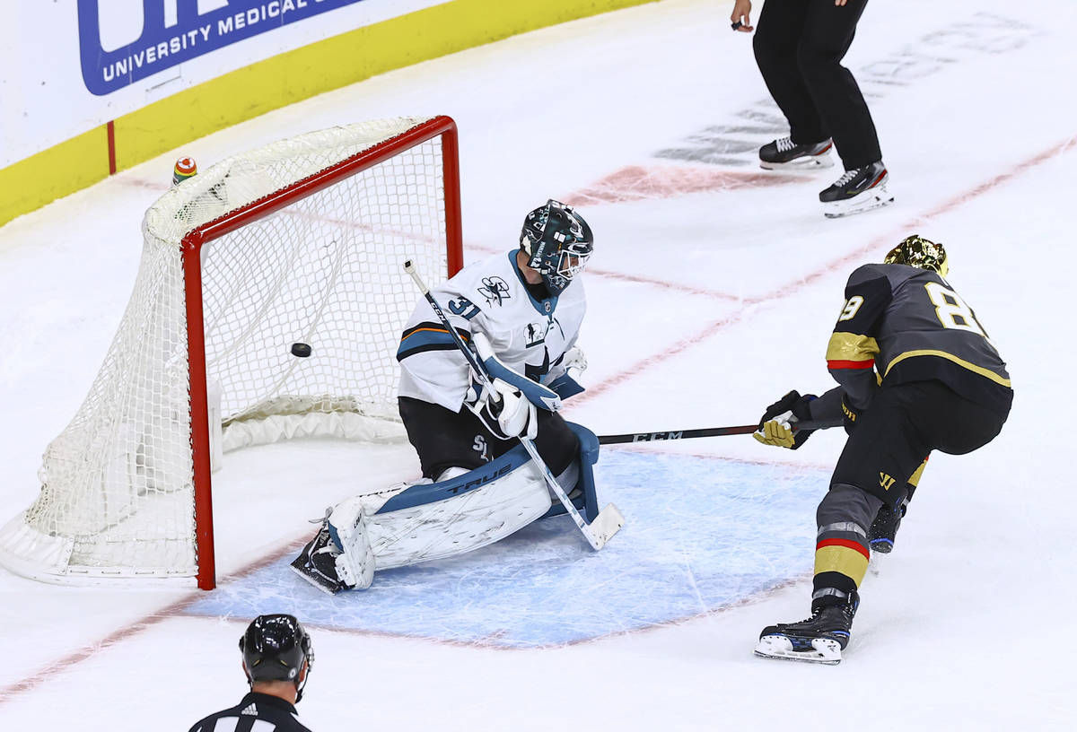 Golden Knights' Alex Tuch (89) scores against San Jose Sharks goaltender Martin Jones (31) in a ...