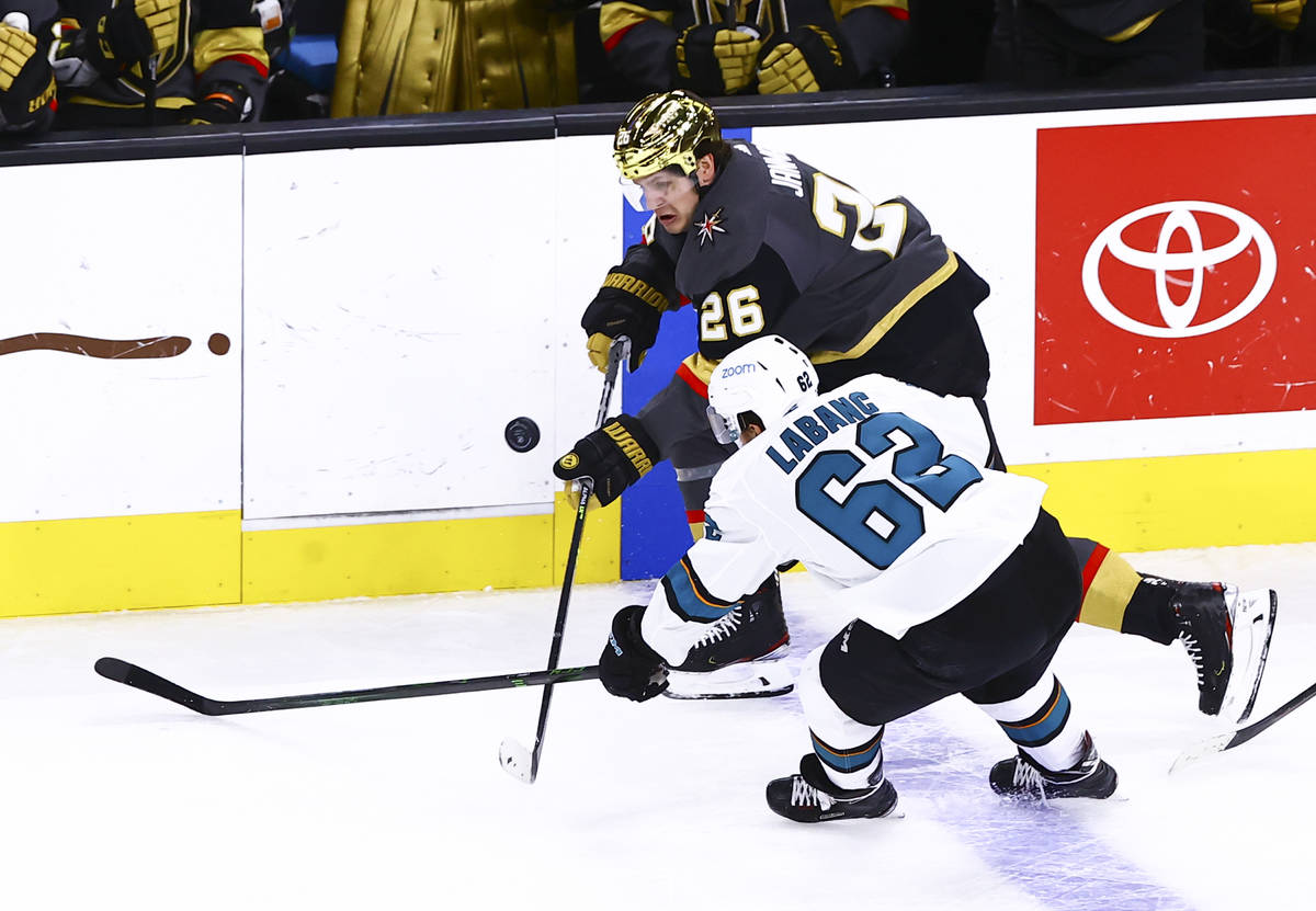 Golden Knights' Mattias Janmark (26) and San Jose Sharks' Kevin Labanc (62) fight for puck duri ...