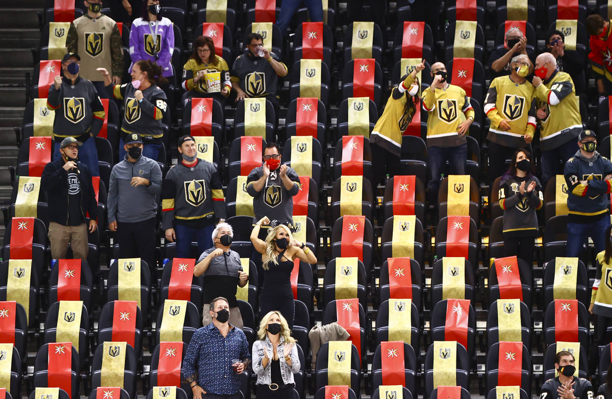 Golden Knights fans celebrate a goal by Mark Stone, not pictured, during the third period of an ...