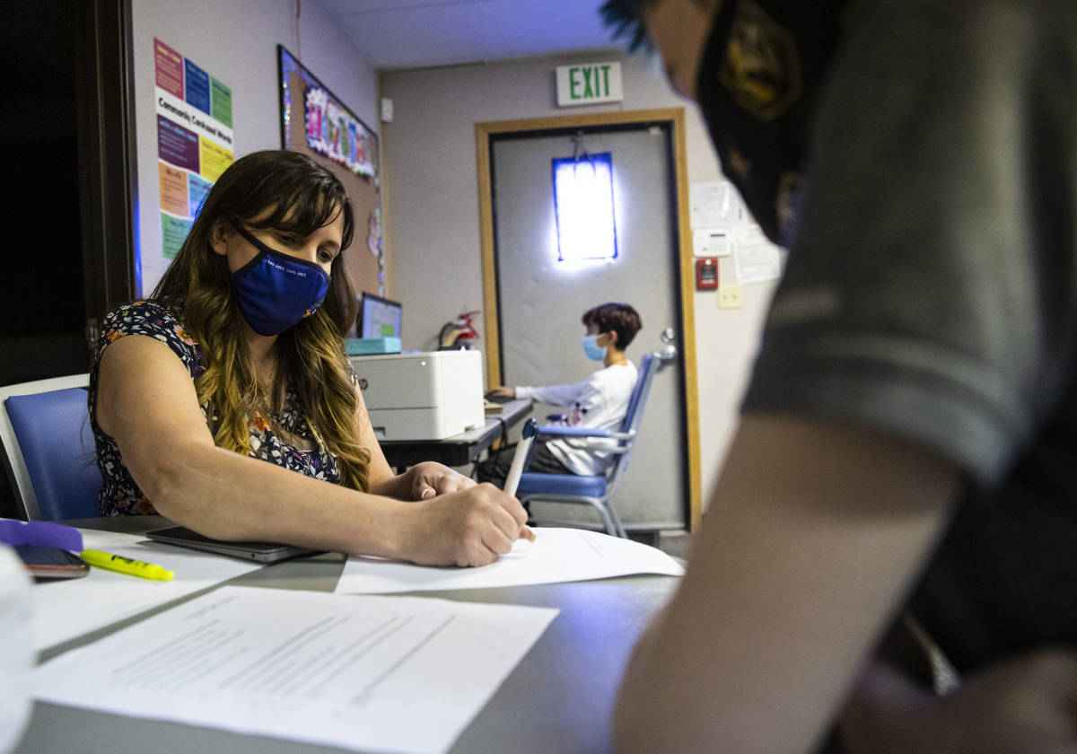 Ashley Campbell, chief of staff at Nevada Action, helps fifth-grader Jack Griffith, 10, during ...