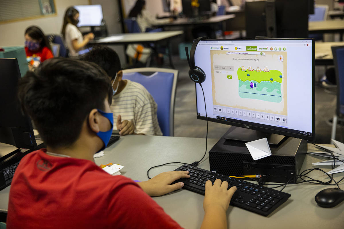 Fifth-grader Michael Bean, 11, works on a math problem during a class at the Southern Nevada Ur ...