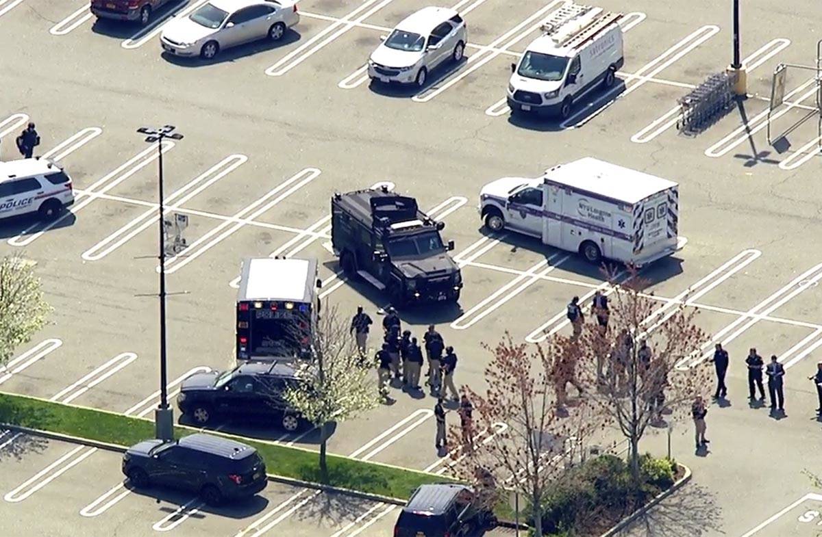 This aerial photo provided by WABC shows police responding to the scene of a shooting at a Stop ...