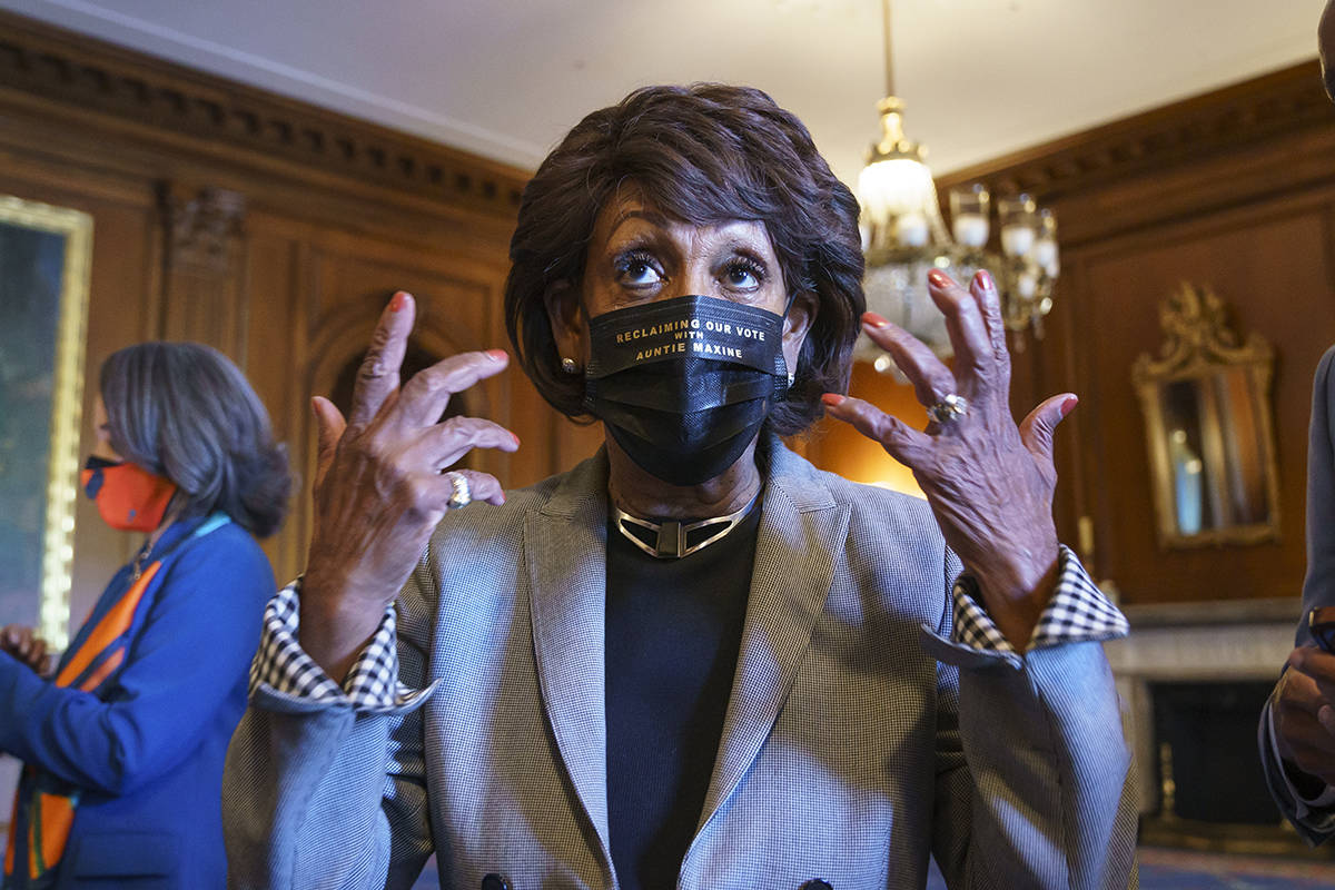 Rep. Maxine Waters, D-Calif., joins members of the Congressional Black Caucus to await the verd ...