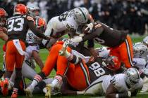 Las Vegas Raiders running back Josh Jacobs (28) leaps over against the Cleveland Browns defende ...