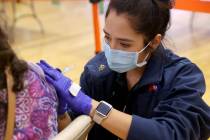 Ideco Flores, an Advanced Emergency Medical Technician with American Medical Response, vaccinat ...