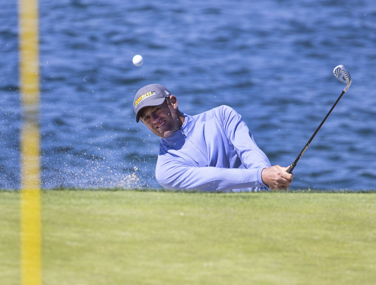 Jamie Arnold of Sydney, Australia, hits out of a bunker on the fourth hole during the first ro ...