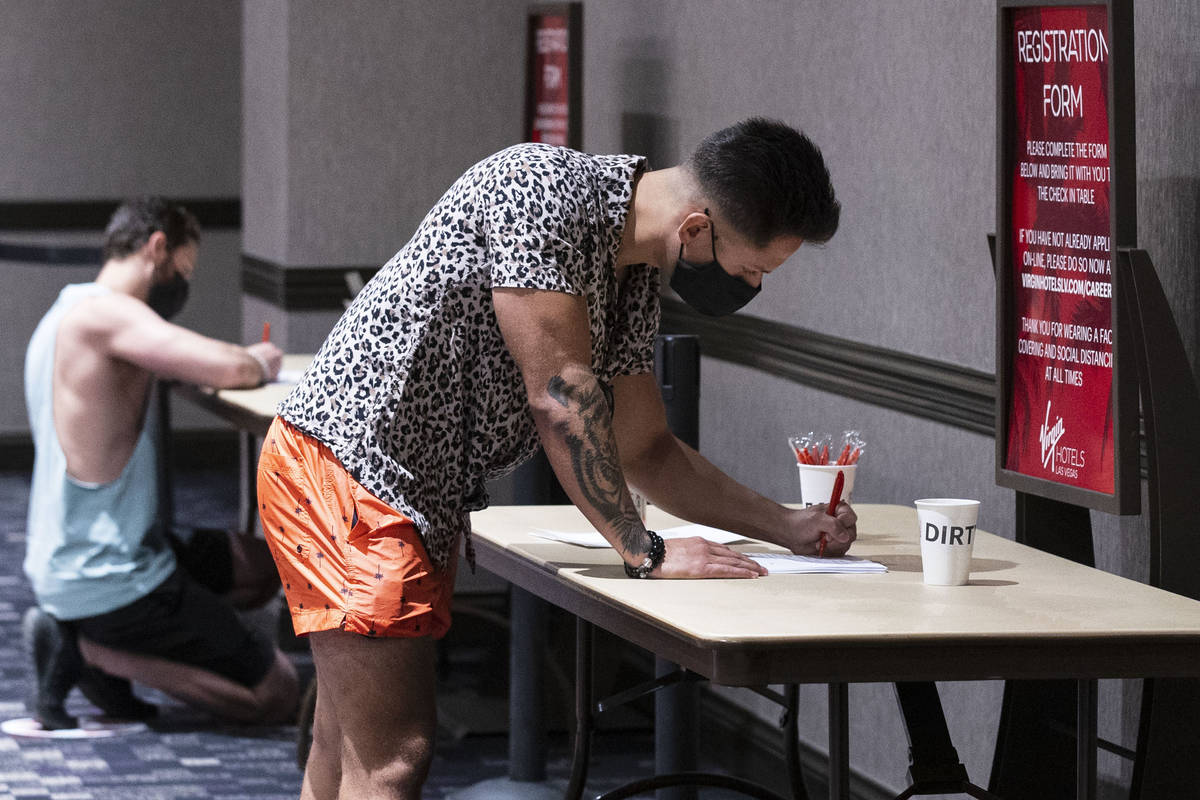 Donovan Garcia fills out application as he applies for pool bartender position at Virgin Hotels ...
